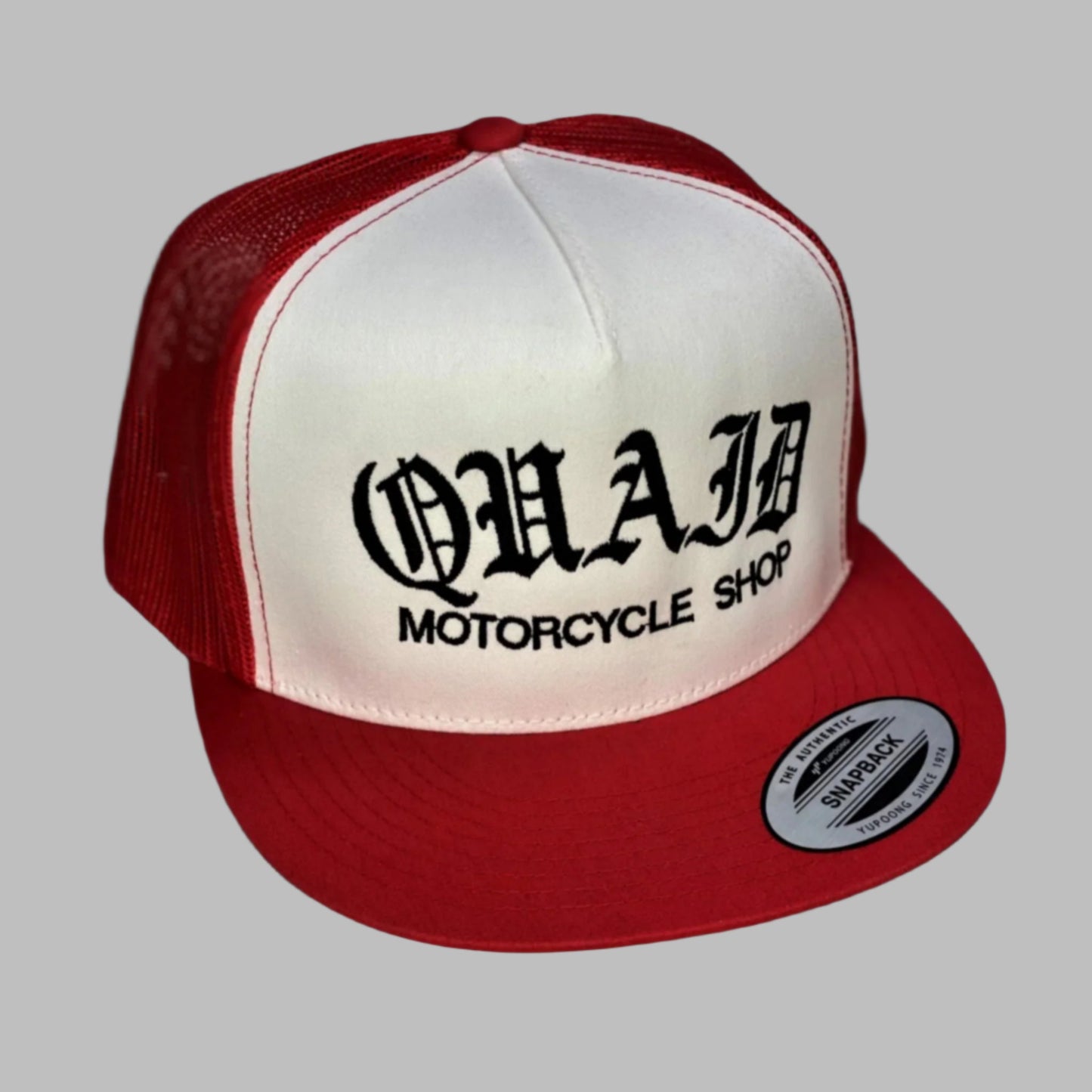 Quaid Motorcycle Shop flexfit trucker cap in two-tone red and white with black stitching for sale at Quaid Motorcycle Shop or at Quaid Harley-Davidson in Loma Linda, Ca.