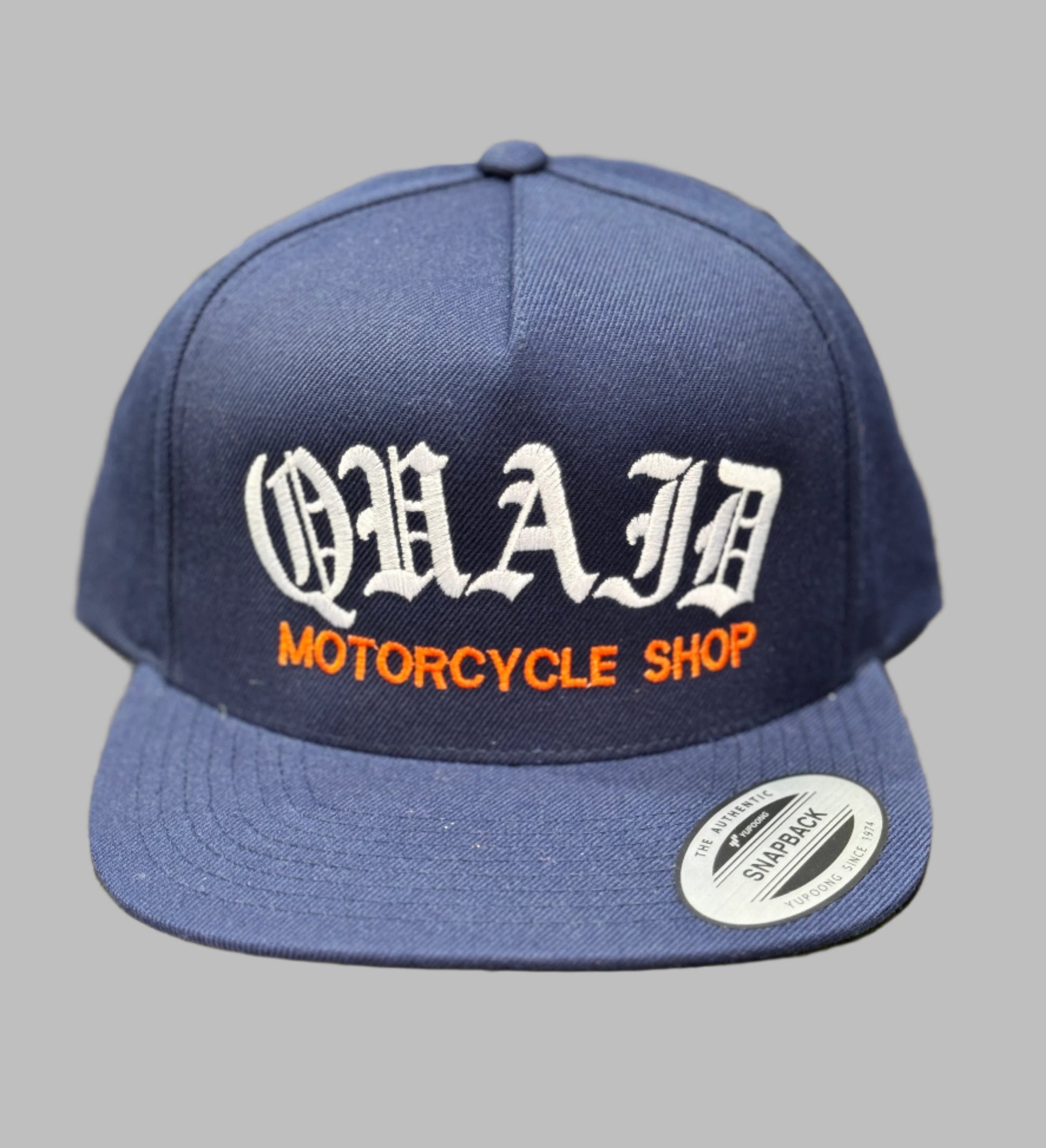 Quaid Harley-Davidson motorcycle shop classic trucker hat in blue with white and orange stitching